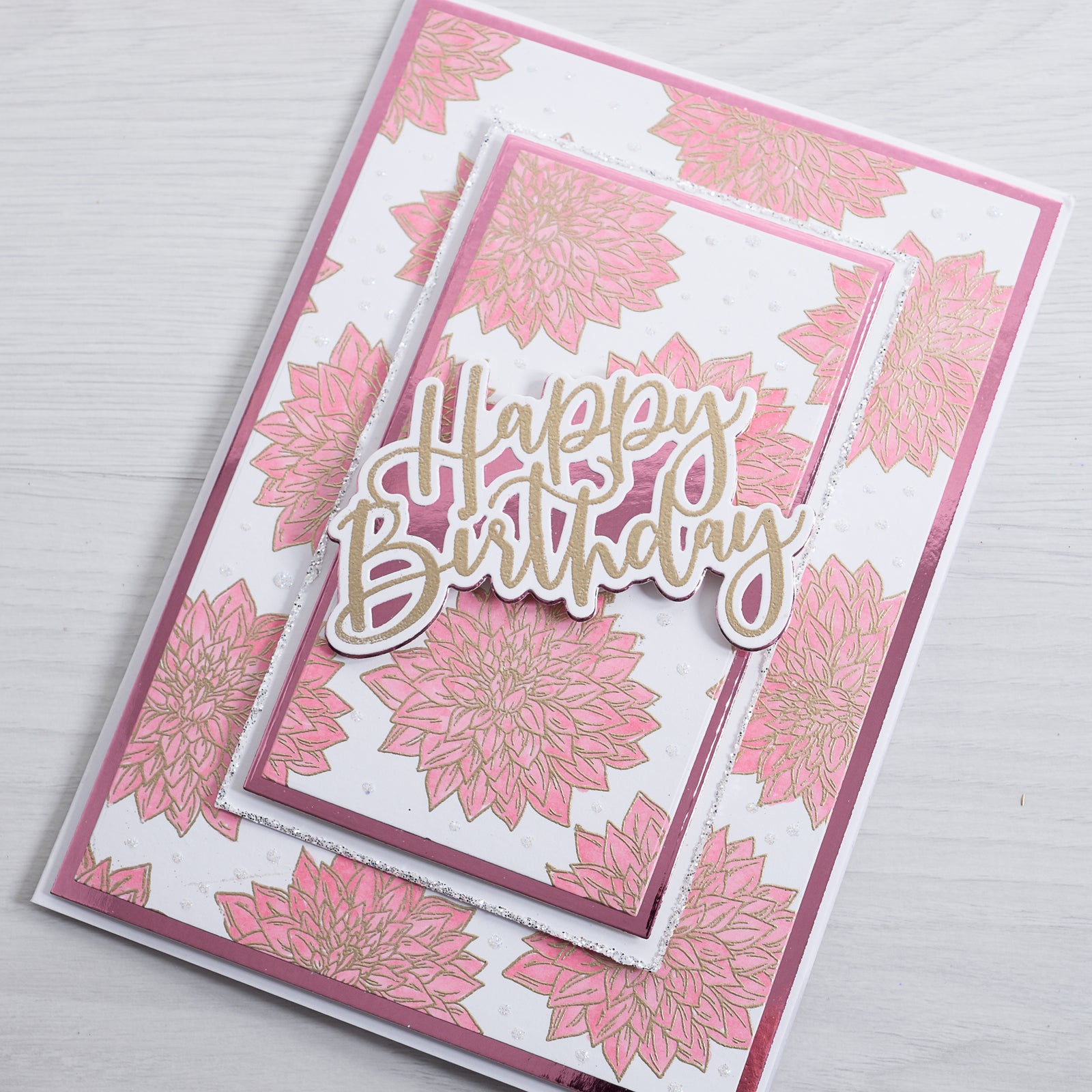 Learn how to create this beautiful pink patterned dahlia flowered Birthday Card with our quick and easy tutorial from Chloes Creative Cards.