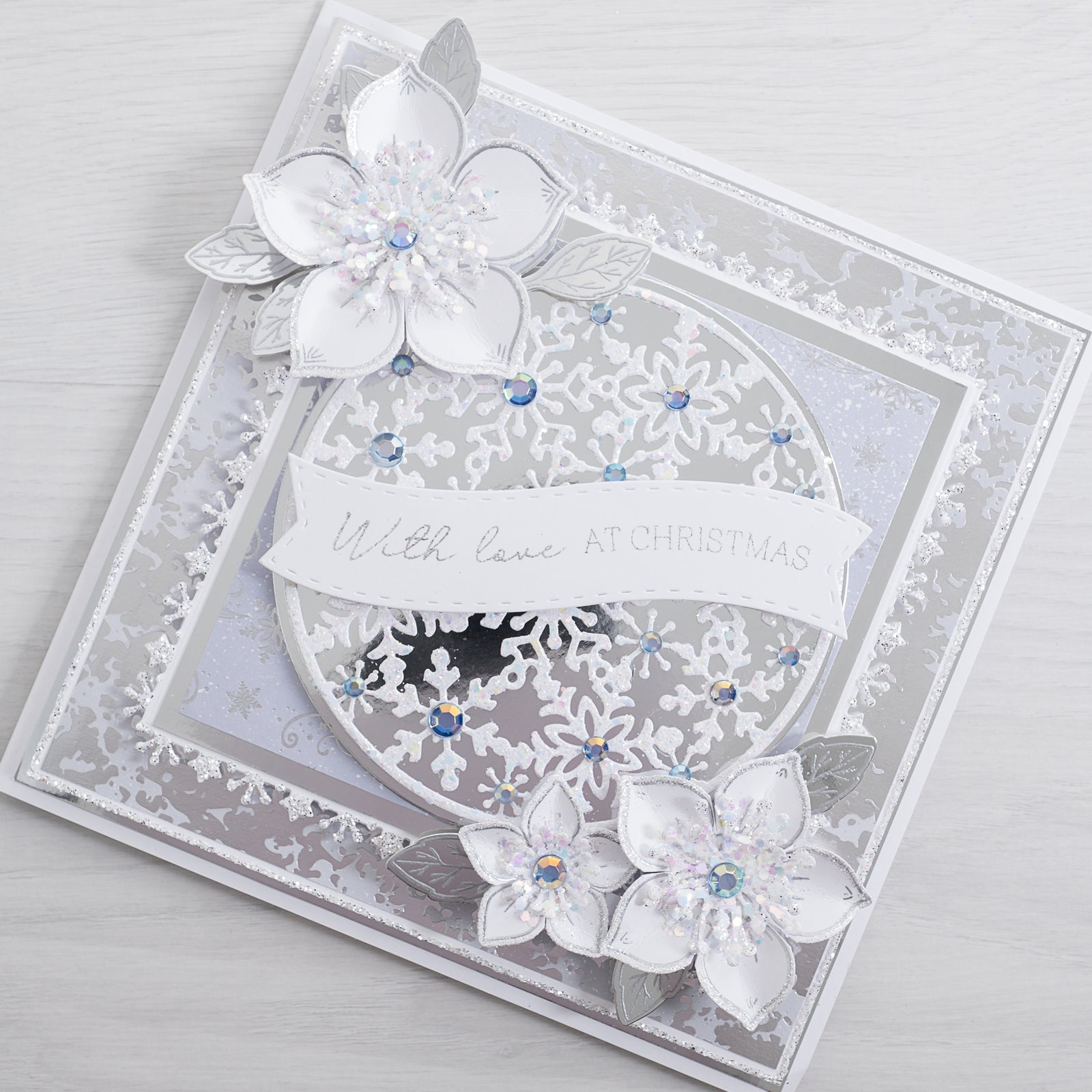 Learn how to create this magical silver snowflake Christmas card using our silver mirror card layered with our Snowflake Circle and Christmas Rose Stamps.