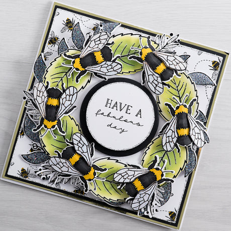 Learn how to make this gorgeous illustrated bee wreath style greetings card using products from Chloes Creative Card. This card is filled with colourful detail and glitter accents - ideal for a Queen Bee herself